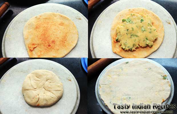 Make a small roti from dough, spread little oil, sprinkle some red chili powder and place aloo mixture in center. Seal the edges and roll into a round disc Make a small roti from dough, spread little oil, sprinkle some red chili powder and place aloo mixture in center. Seal the edges and roll into a round disc