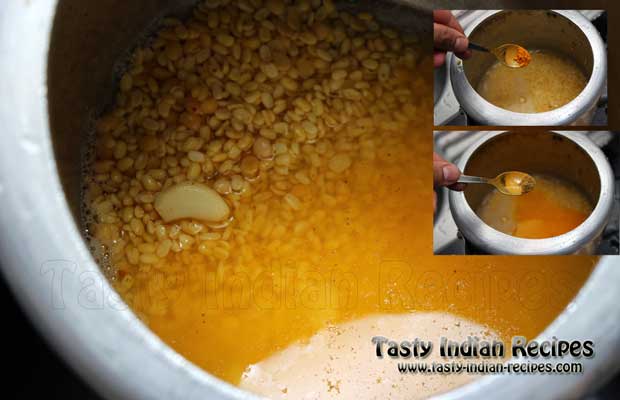 Pressure Cook Dal by adding red chilli powder, turmeric powder, coriander powder, whole pods of garlic and salt to taste Pressure Cook Dal by adding red chilli powder, turmeric powder, coriander powder, whole pods of garlic and salt to taste