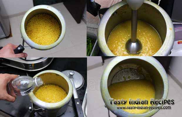 Open the lid of pressure cooker, add water and blend it with an electric beater to make dal lump free Open the lid of pressure cooker, add water and blend it with an electric beater to make dal lump free