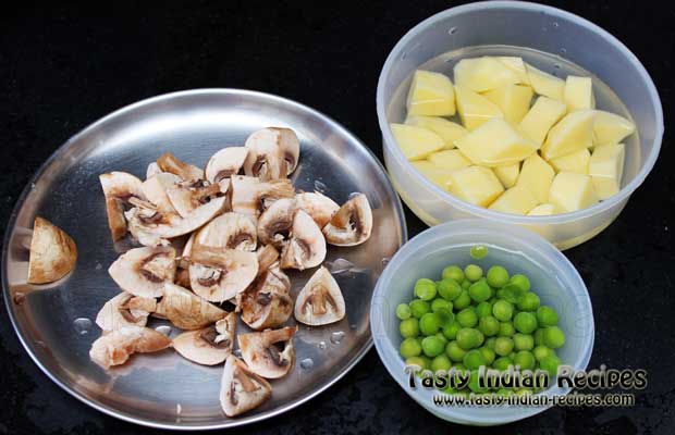 Chop mushroom in slices. Also chop the potatoes in cubes and put the green peas in water Chop mushroom in slices. Also chop the potatoes in cubes and put the green peas in water